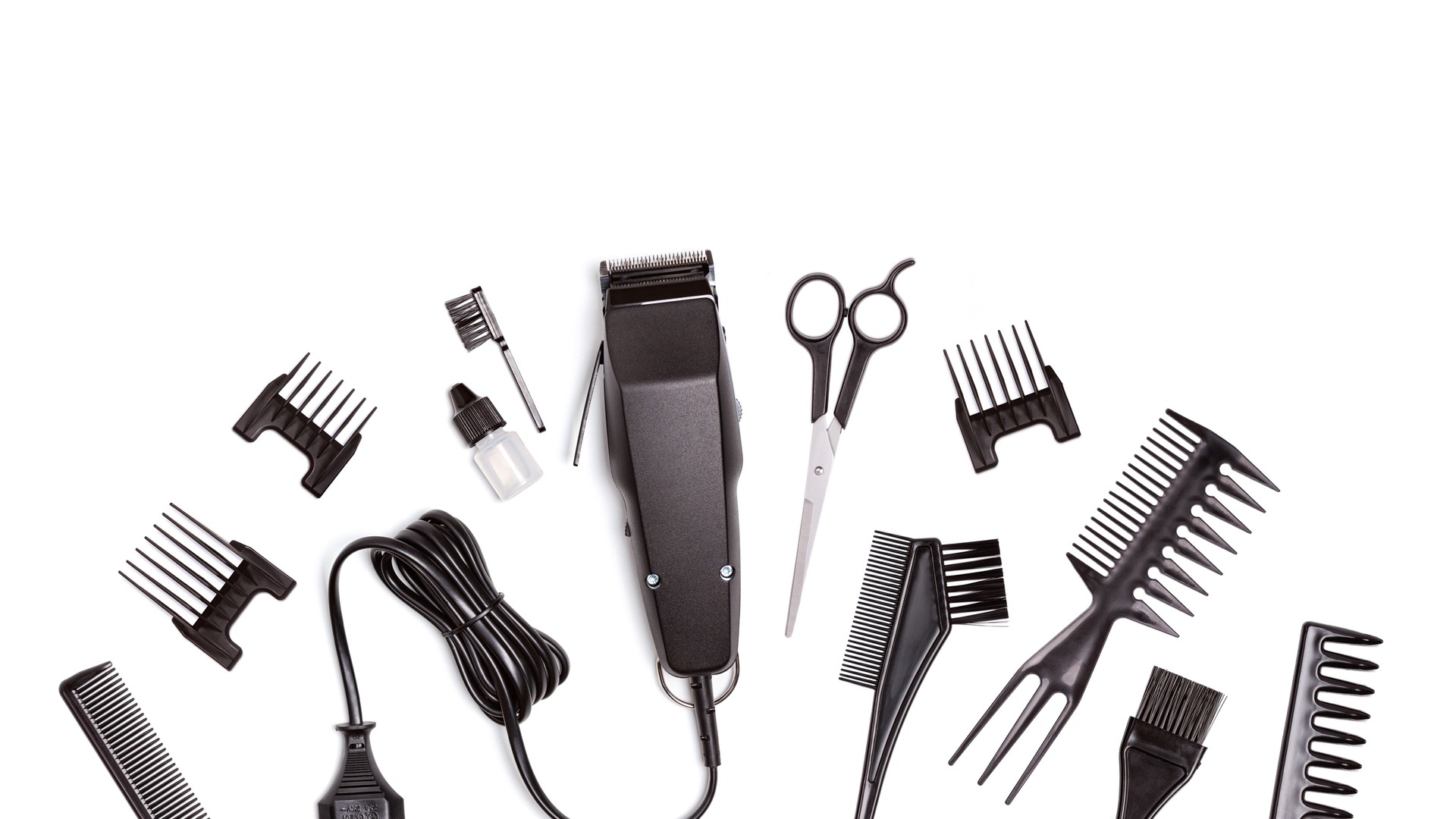 Professional hair clipper with set of nozzles of different sizes isolated on white background